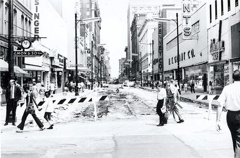 After Fourth Street's road bed was peeled away in preparation for mall work, the old streetcar lines can still be seen running down the center of the street. (Brokn Archives)
