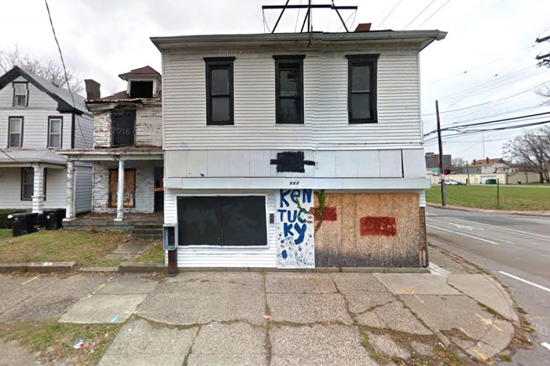 The boarded up grocery store building today. (Google Street View)