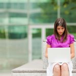 businesswoman using laptop outdoors