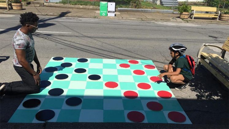 A game of checkers in the street. (Courtesy Center for Neighborhoods)